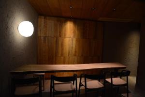 a table and chairs in a room with a light at 湯の里いけもり別館 天座 in Himi