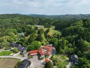 an aerial view of a house in the woods at 湯の里いけもり別館 天座 in Himi