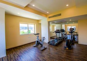 a gym with two treadmills and two exercise bikes at Bloom Hotel - Gachibowli in Hyderabad