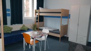 a small room with a table and a bunk bed at Hostel Inn-Berlin in Berlin