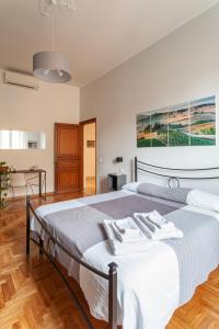 a bedroom with a bed with two towels on it at Il Melograno Holiday House in Rome