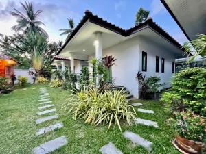 a house with a lawn in front of it at Shine of Hill Lamai Koh Samui in Lamai