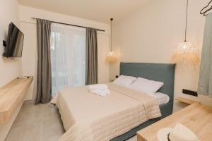 Postel nebo postele na pokoji v ubytování Olvion Suites