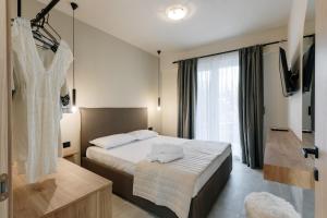 Postel nebo postele na pokoji v ubytování Olvion Suites