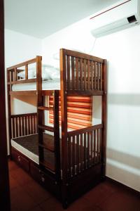 two bunk beds in a room with a wall at Back Packers Cochin Villa in Cochin