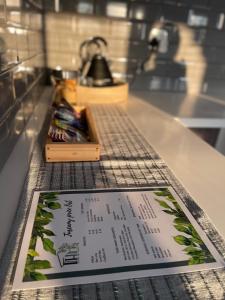 a table with a menu on a counter with a counter top at Tuscany Hill Manor in Hartswater