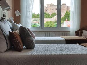 a bedroom with two beds and a large window at Insula Barataria in Belmonte