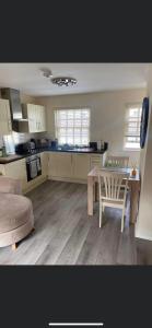 a kitchen with a table and a table and a chair at 2 Bedroom duplex apartment in Bawtry