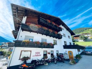 a building with motorcycles parked in front of it at Hotel Marienhof- Erstes Motorradhotel in Fliess! in Fliess