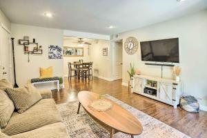 a living room with a couch and a tv at Stylish Dana Point Getaway 1 Mi to Beach! in Dana Point