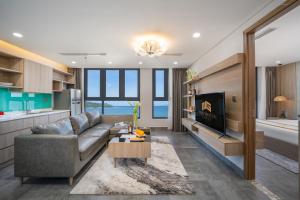 a living room with a couch and a tv at Nguyen Gia Hotel in Da Nang