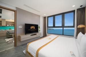 a bedroom with a bed and a tv and a bathroom at Nguyen Gia Hotel in Da Nang