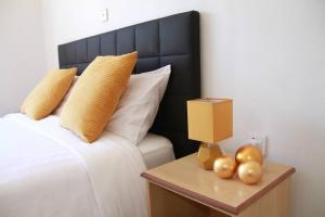 a bedroom with a bed and a table with fruit on it at North Manor Nakuru in Nakuru