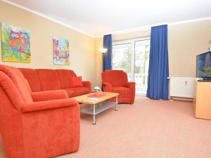 a living room with a couch and two chairs and a tv at Ferienwohnungen Schulte in Baabe