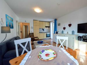 a living room with a table with a cake on it at Fewo Strandallee - Baabe in Baabe