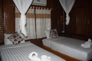 Postel nebo postele na pokoji v ubytování Sengahloune Resort