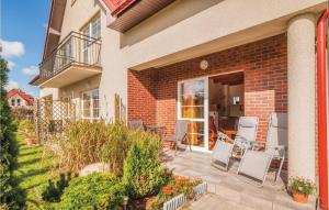 ein Backsteinhaus mit Stühlen und einer Terrasse in der Unterkunft Cozy Apartment In Rowy With Kitchen in Rowy