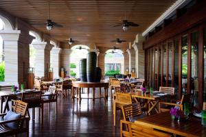 an empty restaurant with wooden tables and chairs at Wanda Reign Resort & Villas Sanya Haitang Bay in Sanya