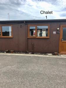 a building with a chalker sign on the side of it at Atlanta Ceder Wood Chalet in Mablethorpe