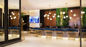 a restaurant with blue bar stools in a room at Le Centell Hotel & Spa in Antananarivo