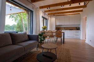 a living room with a couch and a table at Siedlisko Pozorty in Pozorty