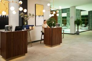 a man sitting at a counter in a lobby at Le Centell Hotel & Spa in Antananarivo +65 photos