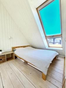 En eller flere senge i et værelse på Cottage in Svencele by Curonian Lagoon
