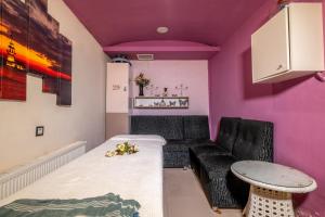 a living room with a couch and purple walls at City Live Hotel in Antalya