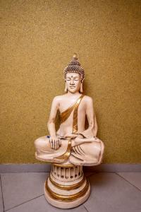 a statue of a buddha sitting on a table at City Live Hotel in Antalya