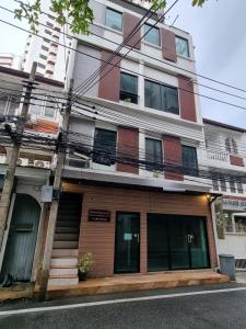 a building on the side of a street at Flourish Apartments Sukhumvit 39 in Bangkok