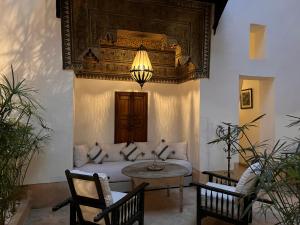 a living room with a couch and a table at RIAD ENNAFOURA BOUTIQUE HOTEL in Marrakesh