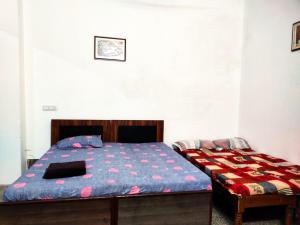 Postel nebo postele na pokoji v ubytování Khushi Paying Guest House