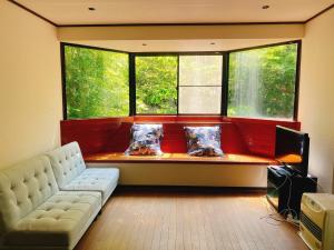 a living room with a couch and two windows at 秩父 思源屋 