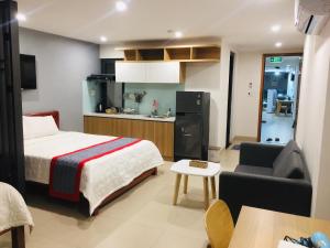 una camera d'albergo con letto e cucina di Hà Linh Apartment a Da Nang