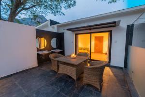 a patio with a table and wicker chairs at DARZA LUXURY RESORTs in Coimbatore