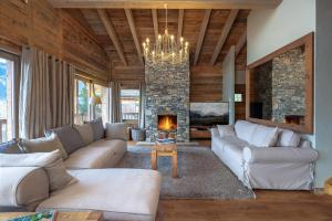 a living room with couches and a fireplace at Chalet Micheline in Riddes
