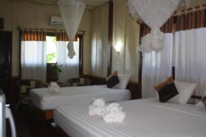 Postel nebo postele na pokoji v ubytování Sengahloune Resort