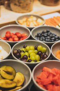 a bunch of bowls filled with different types of fruit at DAS GERLOS - Boutique Hotel in Gerlos