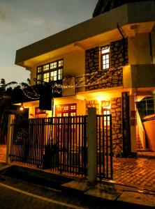 a house with a fence in front of it at Cottage 23 in Kurunegala