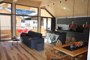 a living room with a couch and a table at Blue Note Apartments in Schoppernau
