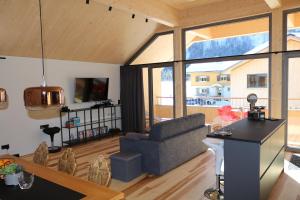 a living room with a couch and a table at Blue Note Apartments in Schoppernau