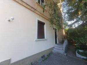 a white house with a window and a staircase at Sonnegg Guest Rooms Inh M Bisegger in Zürich