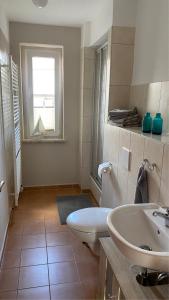 a bathroom with a white toilet and a sink at Alte Feuerwehr Bleicherode in Bleicherode +12 photos