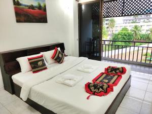 two beds in a room with a balcony at Sea Beach Paradise in Patong Beach