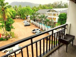 a balcony with a view of a parking lot with cars at Sea Beach Paradise in Patong Beach