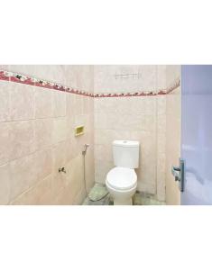 a bathroom with a toilet and a shower at KoolKost Syariah near Stasiun Tanjung Karang Lampung in Bandar Lampung