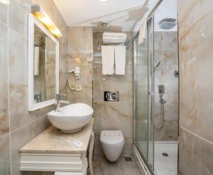 a bathroom with a sink and a shower at Topkapi Old City Kensington Hotel ISTANBUL in Istanbul