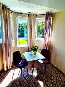 a room with a table and two chairs and a window at Via Hotel Polkowice in Polkowice