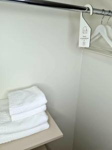 a pile of towels on a shelf in a bathroom at Via Hotel Polkowice in Polkowice