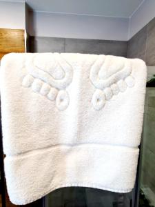 a white towel on a shelf in a bathroom at Via Hotel Polkowice in Polkowice